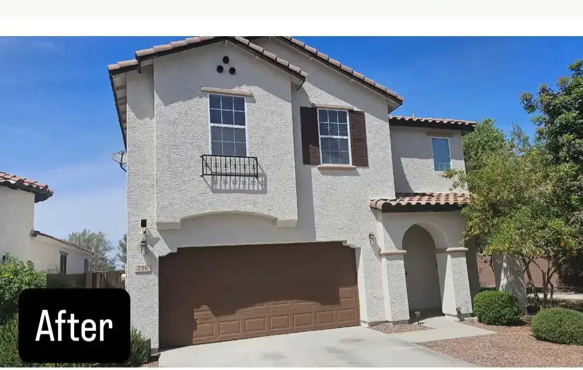 After: the same home in a light stucco color with a new brown garage door