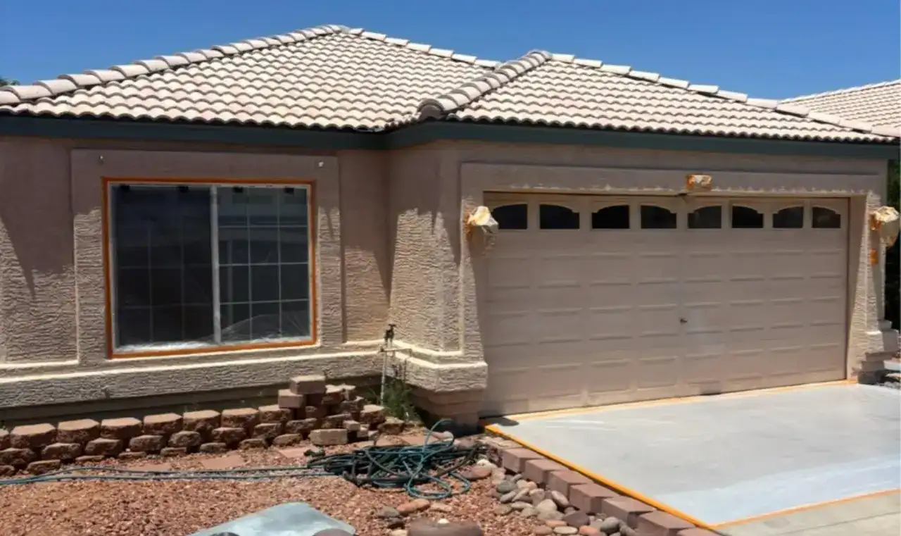Before: single-story home with worn tan paint and an older tile roof