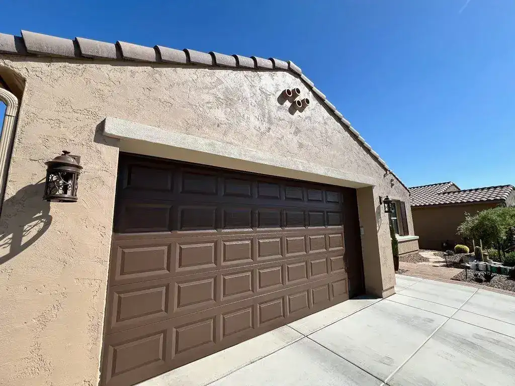 The same garage wall finished in an even tan coat of paint